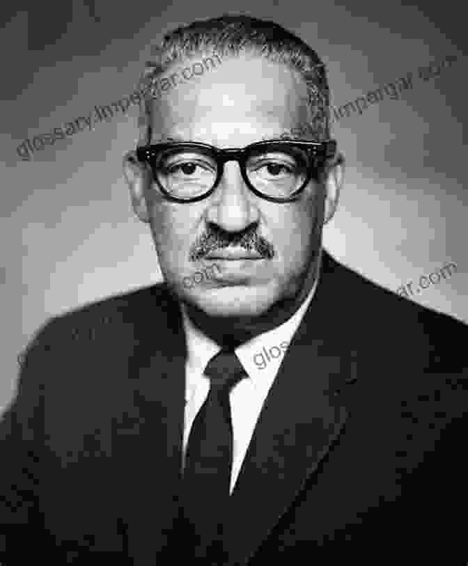 A Black And White Photograph Of Thurgood Marshall, A Bespectacled Man In A Suit, Seated At A Desk With A Law Book And Pen In Front Of Him. A Defiant Life: Thurgood Marshall And The Persistence Of Racism In America