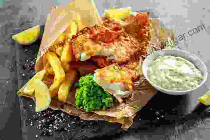 A Golden Brown Pile Of Fish And Chips, Served With Tartar Sauce And Malt Vinegar. British Food A To Z